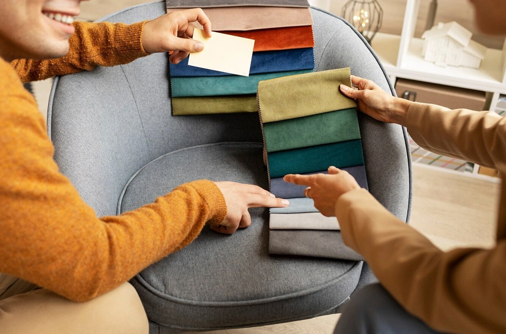 "Two people discussing fabric options with fabric swatches, emphasizing how GSM impacts fabric choice for activewear and sports apparel."